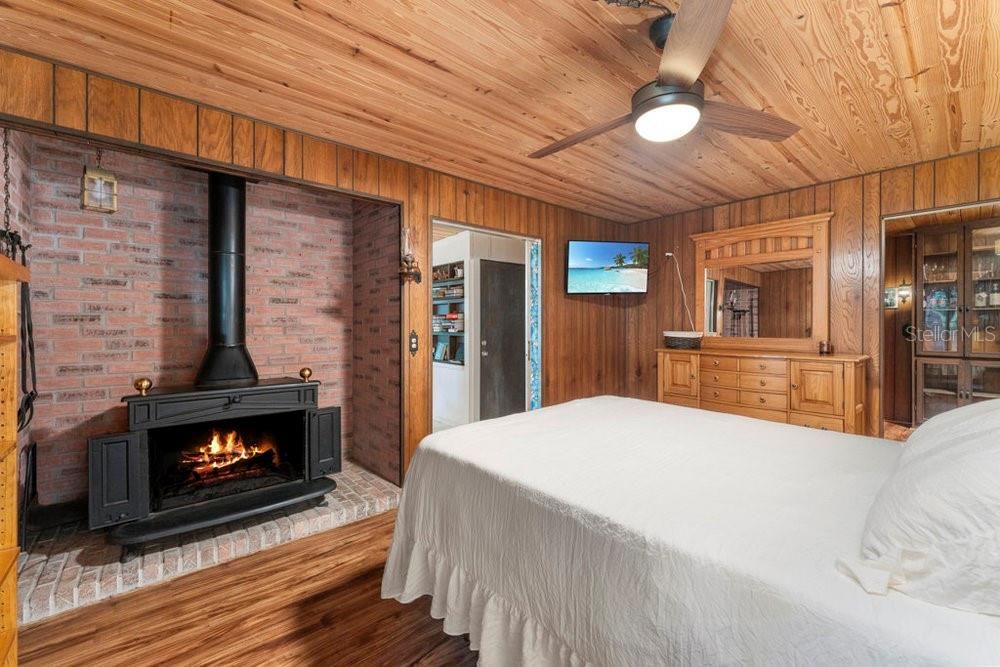 Primary bedroom with wood burning fireplace