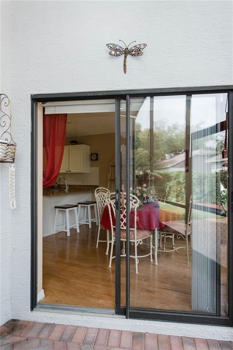 Sliding door to enclosed, screened and paved back porch