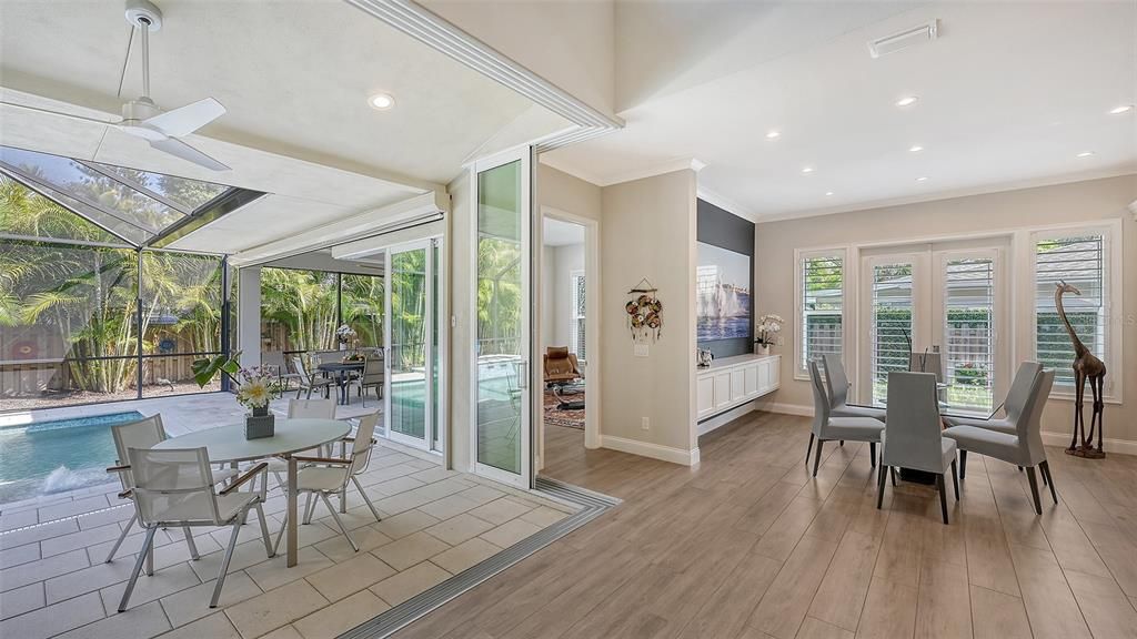 Soaring 18-foot ceilings adorned with a wall of expansive 10-foot sliders beckon you towards a sprawling outdoor oasis, perfect for entertaining