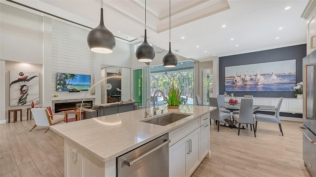 The meticulously designed kitchen features all stainless appliances, 5 burner gas range, Quartz island and counters, ample walk-in pantry and outdoor vistas