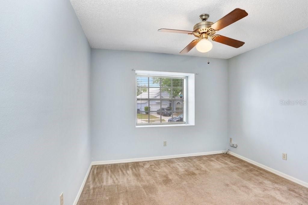 The second bedroom has an adorable window space to sit in or to display some of your favorite plants or collections.  It also features a lighted ceiling fan and a good-sized closet.