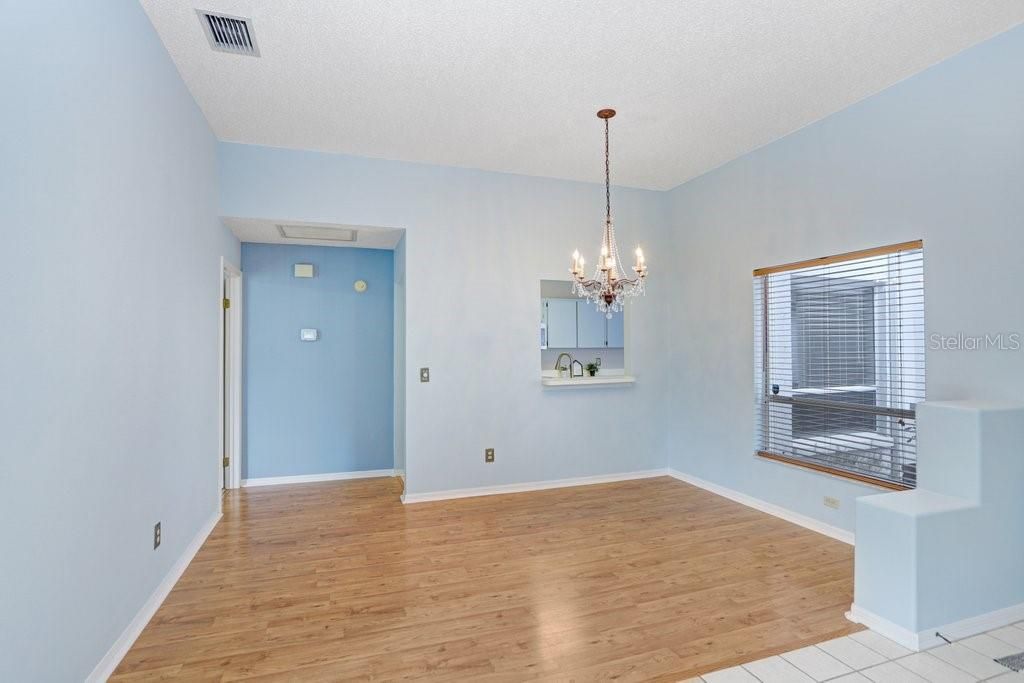 Inside you'll find an open floorplan, a decorative fireplace that will stay, a beautiful chandelier in the dining room, a large sliding glass door to the backyard, a lighted ceiling fan, and lots of natural light!