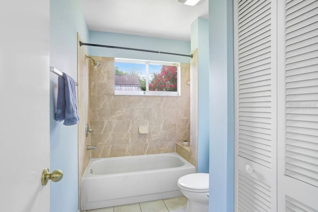 The master ensuite features a walk-in closet, dual sinks, lots of storage cabinets, a linen closet, ceramic tile flooring, a door to the toilet/shower area, and a garden tub/shower combo.