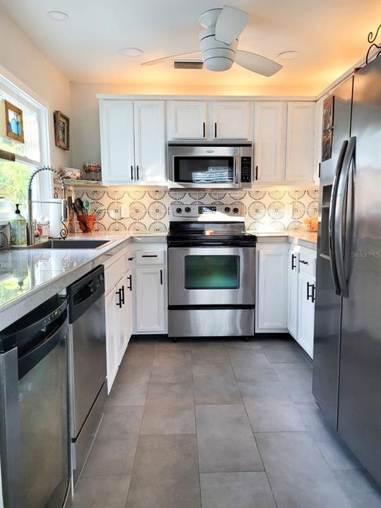 Our kitchen has all the modern appliances one would expect at the home. Appliances include, dishwasher, oven, range, wine cooler, fridge, and microwave.