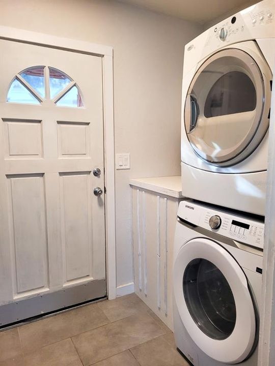 Stackable washer and dryer in the laundry room area