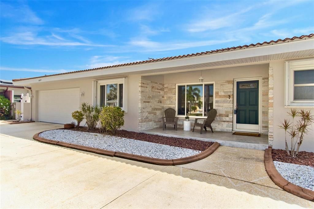 Two car garage (newer hurricane rated garage door), attractive mid-century flare entry, and low maintenance landscaping are a winning combination!