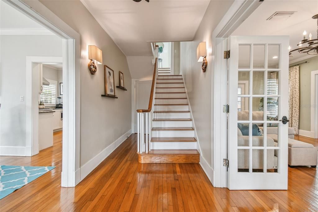 Original, refinished oak floors; traditional living and dining rooms flank a graceful staircase
