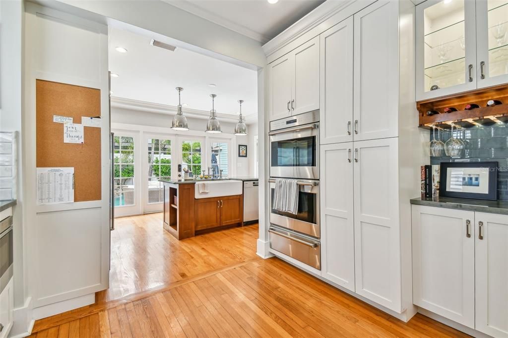 Quartz countertops and French doors with a gorgeous view of the pool/covered outdoor lanai