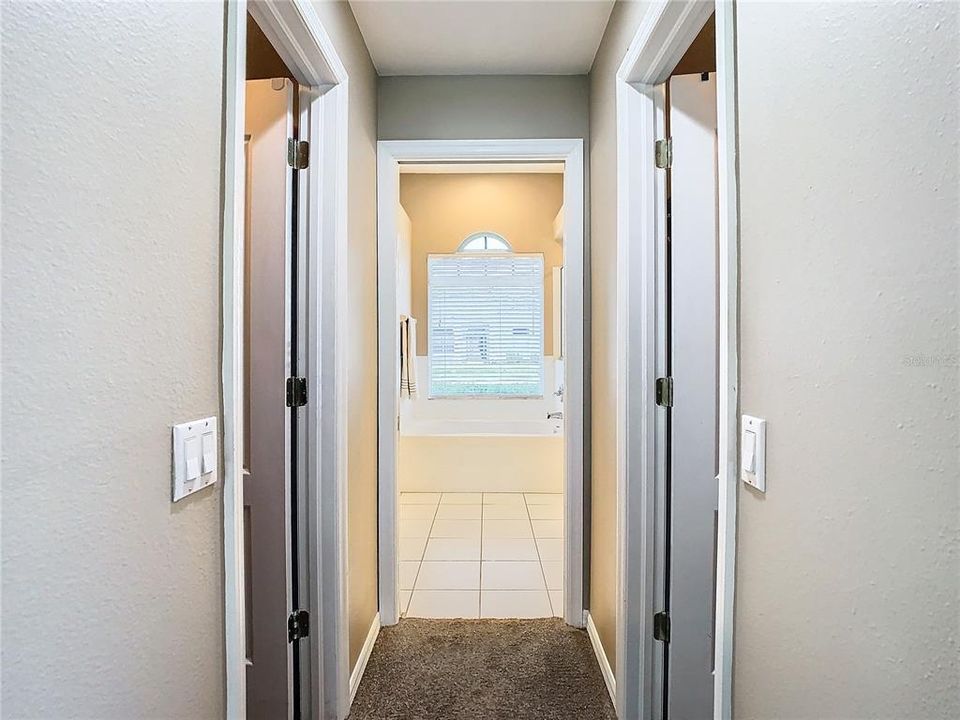 Dual closets lead to the spacious primary bathroom.