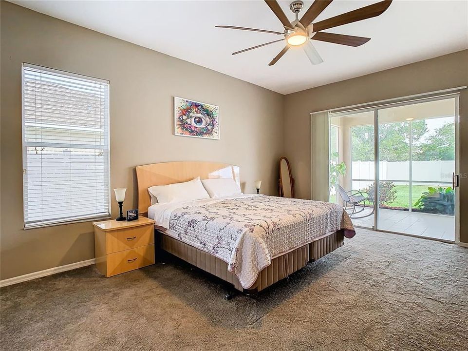 Primary bedroom with patio access.  High ceilings throughout the home.