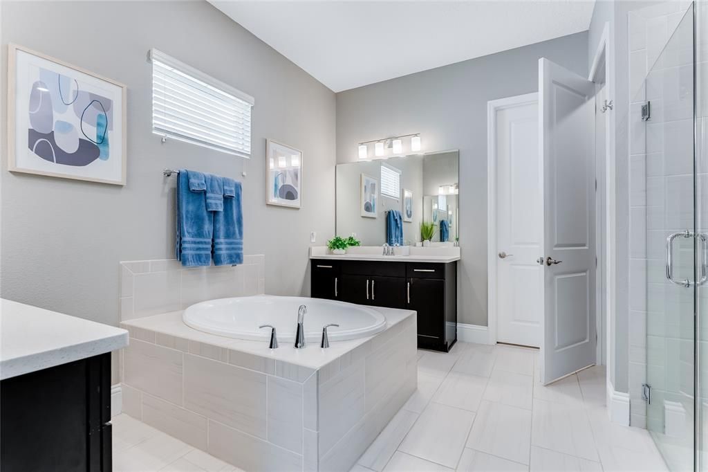 The center soaking tub provides perfect separation between the two vanity areas.