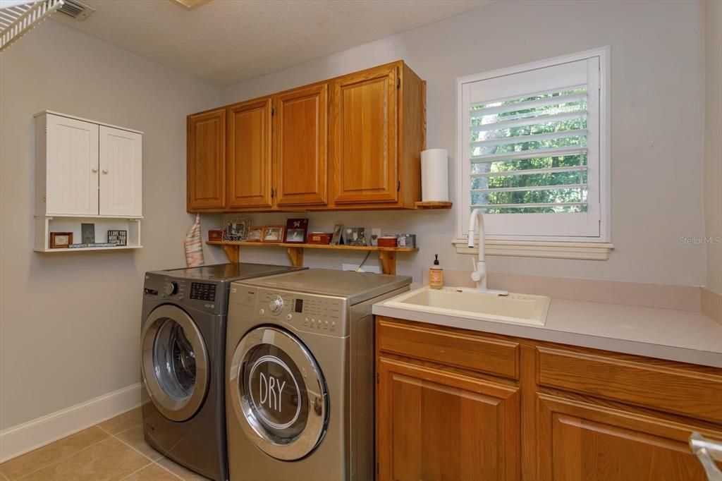Spacious laundry room with laundry sink