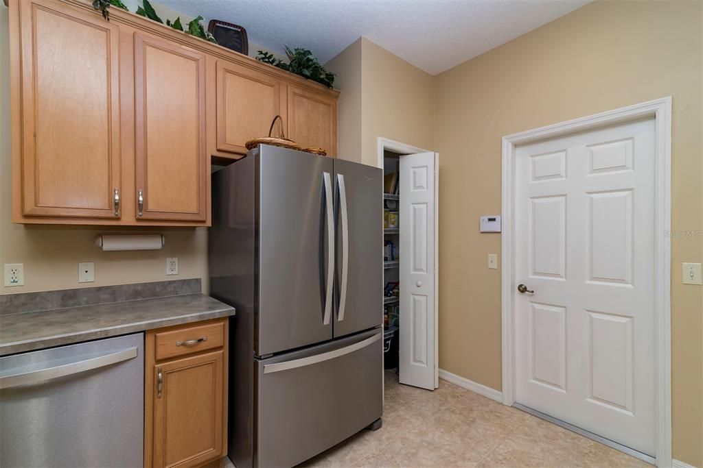 Next to the French door refrigerator is the kitchen closet pantry.
