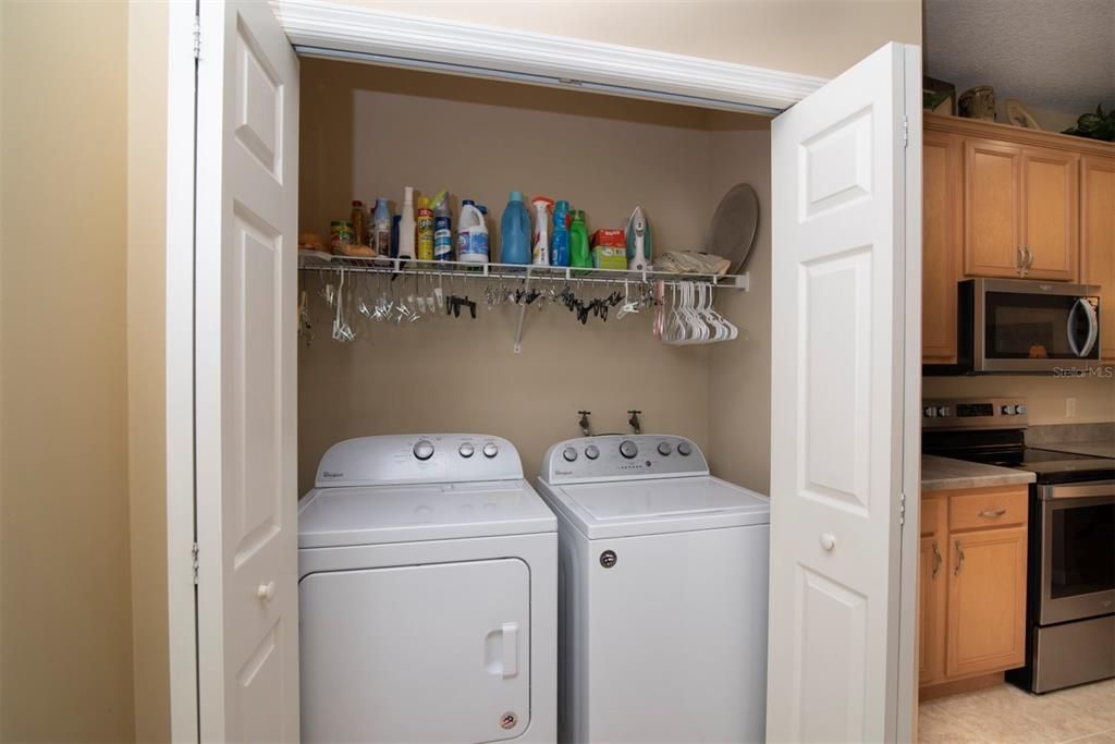 The laundry cabinet in the kitchen. The washer and dryer stay for the new owners.