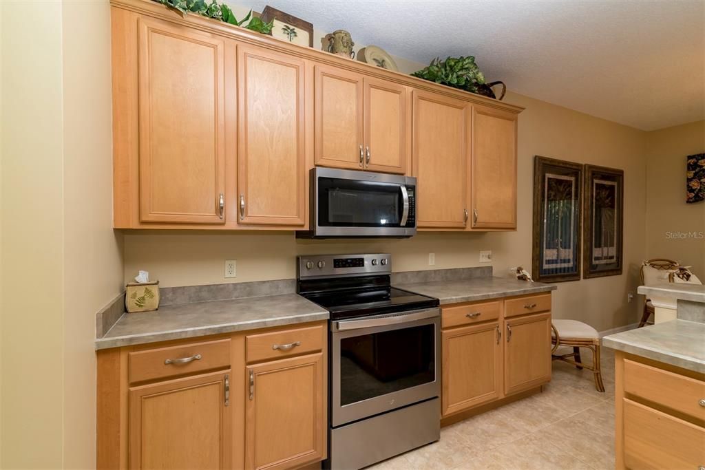 The kitchen has lots of cabinets and countertops.