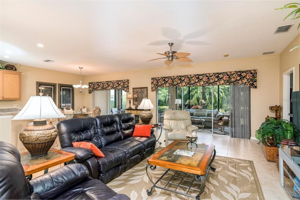 The large living room of this open floor plan home has quality ceramic tile flooring.