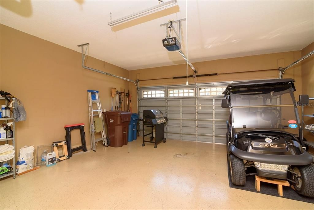 The attached 2 car garage has epoxy floor paint, opener, and windows in the garage door for natural light.