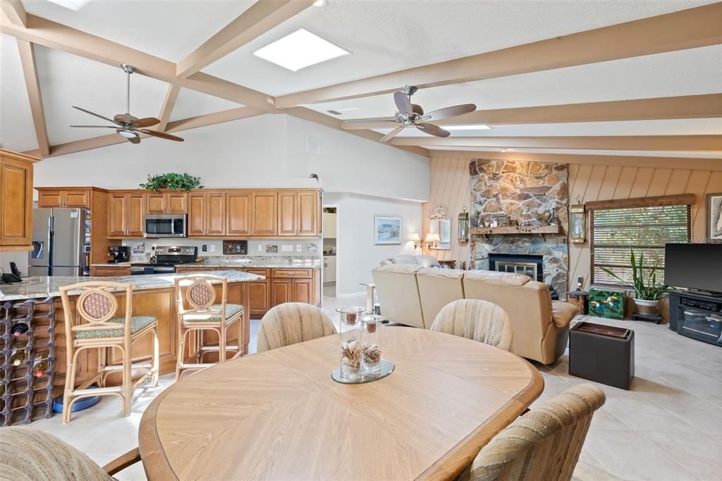 View of the Family Room and Kitchen from Breakfast Area- Sliding Doors to the Pool. Notice the skylight for natural light!