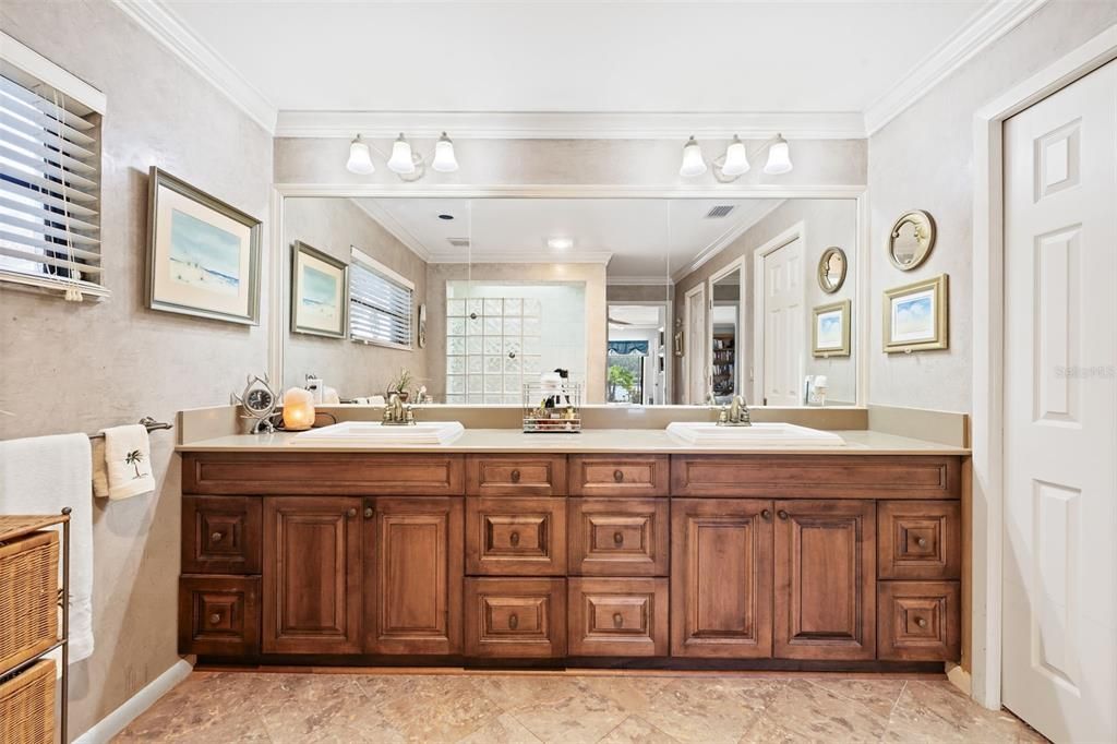 Beautiful marble tile flooring with wood vanity and double sinks! Walk in Closet to the right.Custom Venetian plaster installed in all baths!