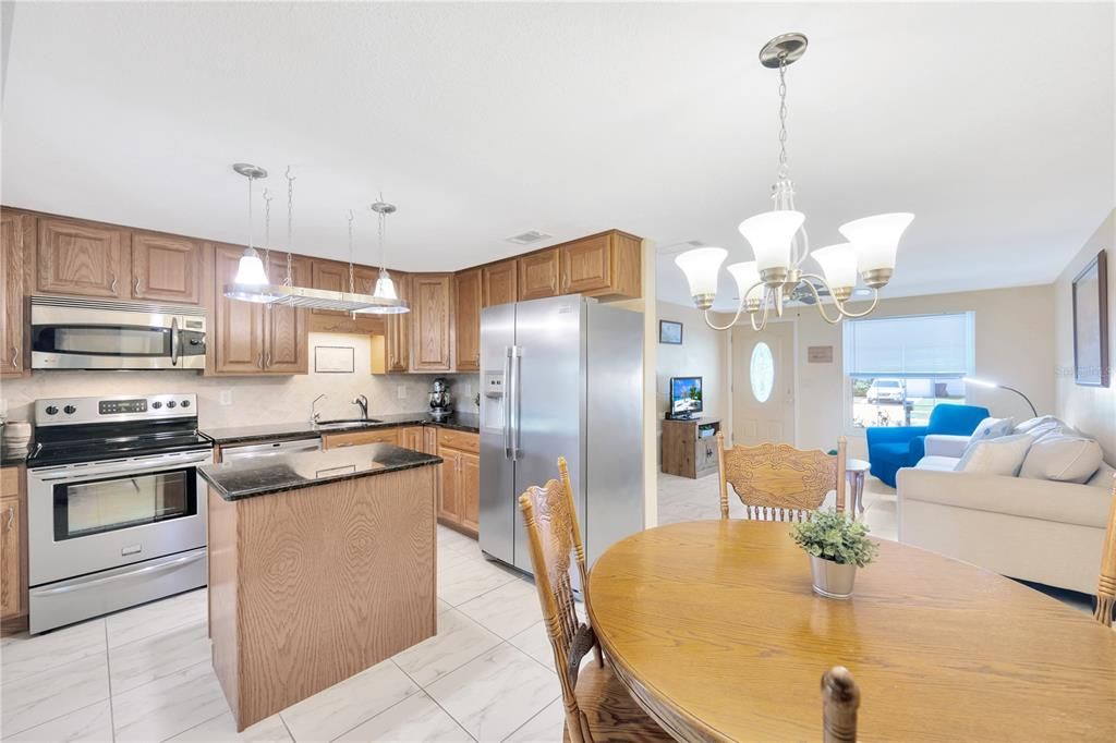 Upgraded Kitchen w/ Hardwood Cabinets, Stainless Steel Appliances, Granite Counters, & Island w/ Storage.
