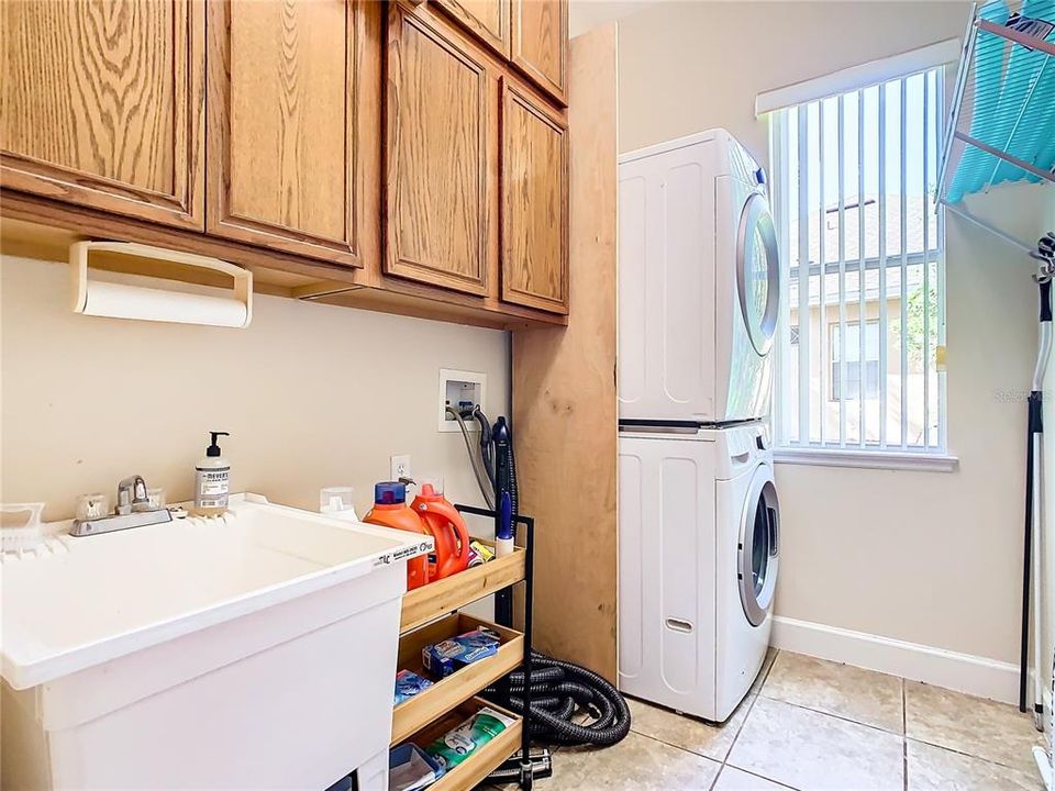Laundry room with utility sink and storage