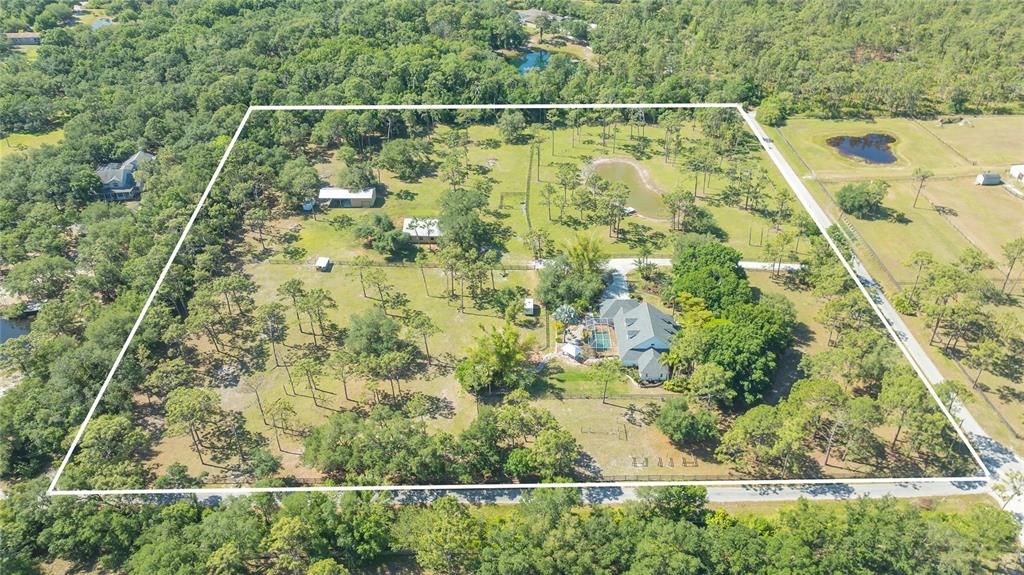 No wetlands, 9+ acres fenced and cross fenced, ready for you and your family.  The home is stunning, but the property also includes a large concrete 6 stall 48 x 34 barn (electric, water is at the barn), with metal roof and a 2nd building that measures 24 x 60, also with a metal roof.