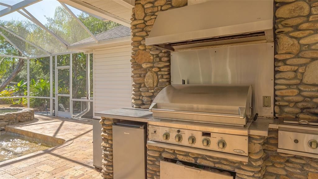 This summer kitchen is waiting for you to bring the "steaks on the barbie"!  It comes with the big gas grill, as well as a refrigerator and steam burner.