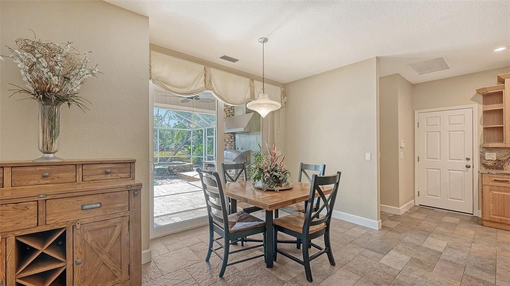 Sliders lead from the breakfast nook to the outdoor entertainment area.