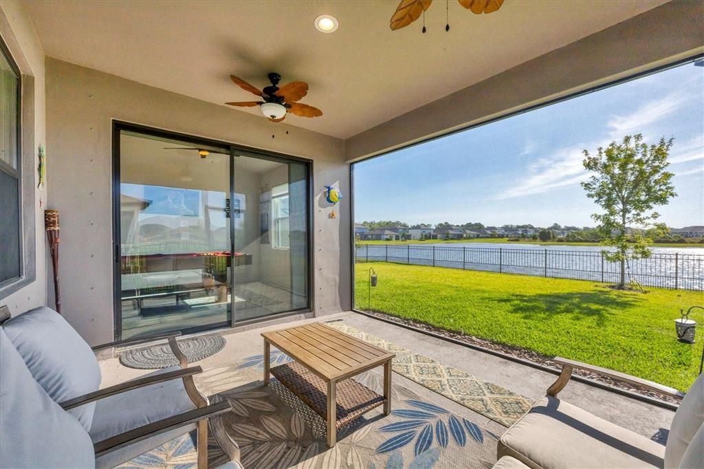 LANAI WITH PANORAMIC SCREEN ENCLOSURE, DUAL CEILING FANS, POND VIEW