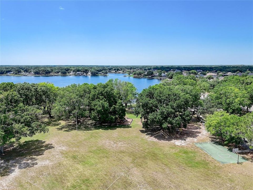 Main community park with lake access, boat launch, basketball, tennis, playgrounds, picnic areas.