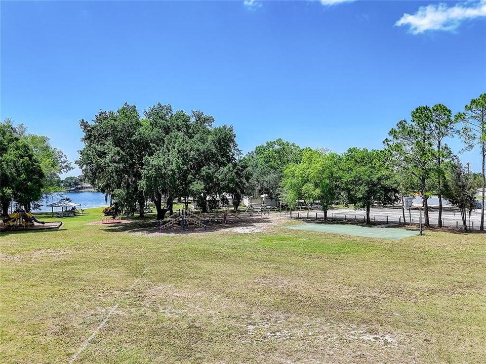 Main community park with lake access, boat launch, basketball, tennis, playgrounds, picnic areas.