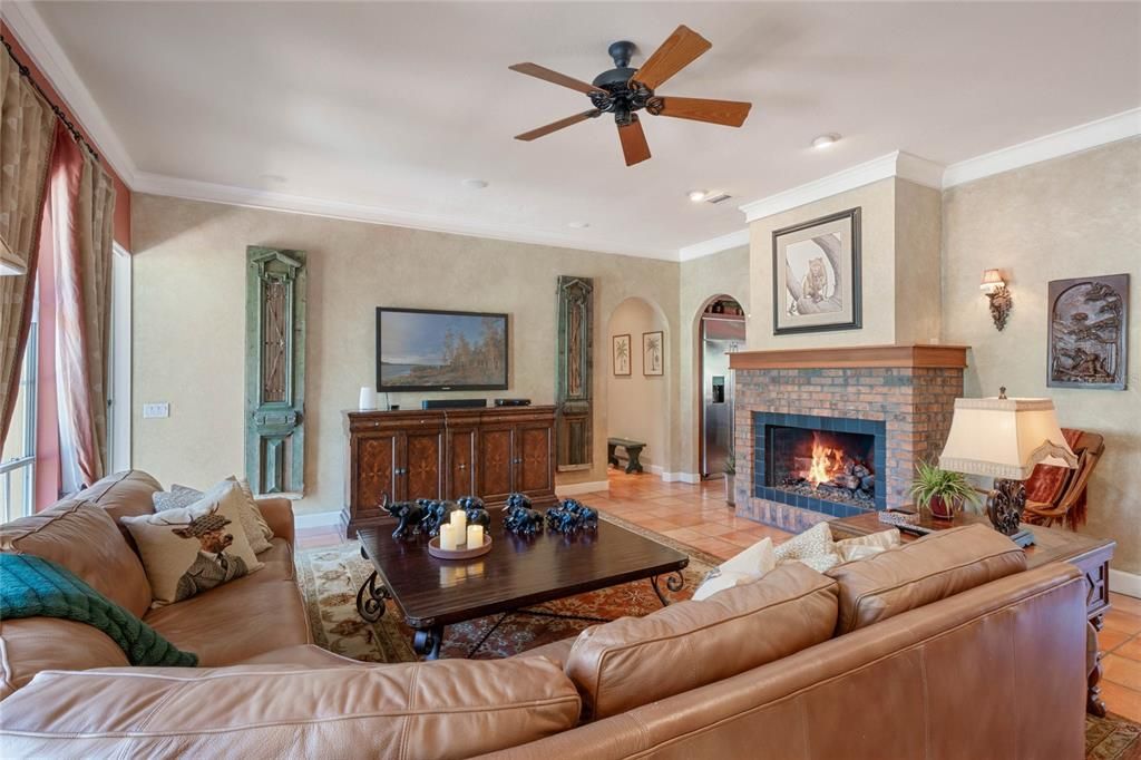 Warm and inviting family room has gas fireplace