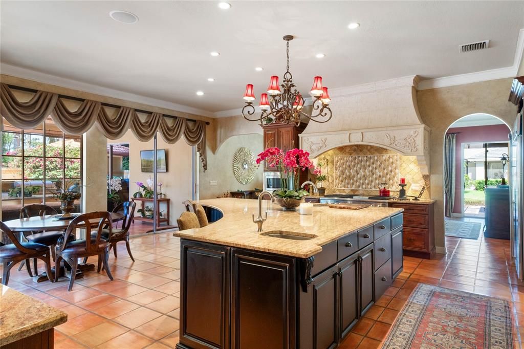 Your spacious gourmet kitchen opens to your screened summer kitchen - this is resort living!