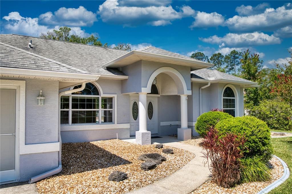 A gracefully designed walkway leads to the stately columned front entry, covered to provide shelter and comfort as you enter the home. This architectural feature adds a touch of grandeur and a welcoming atmosphere that is sure to impress visitors and provide a majestic arrival experience.