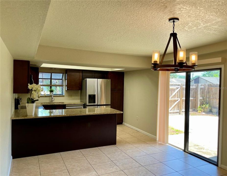 Dining and Kitchen with views of private outdoor patio.