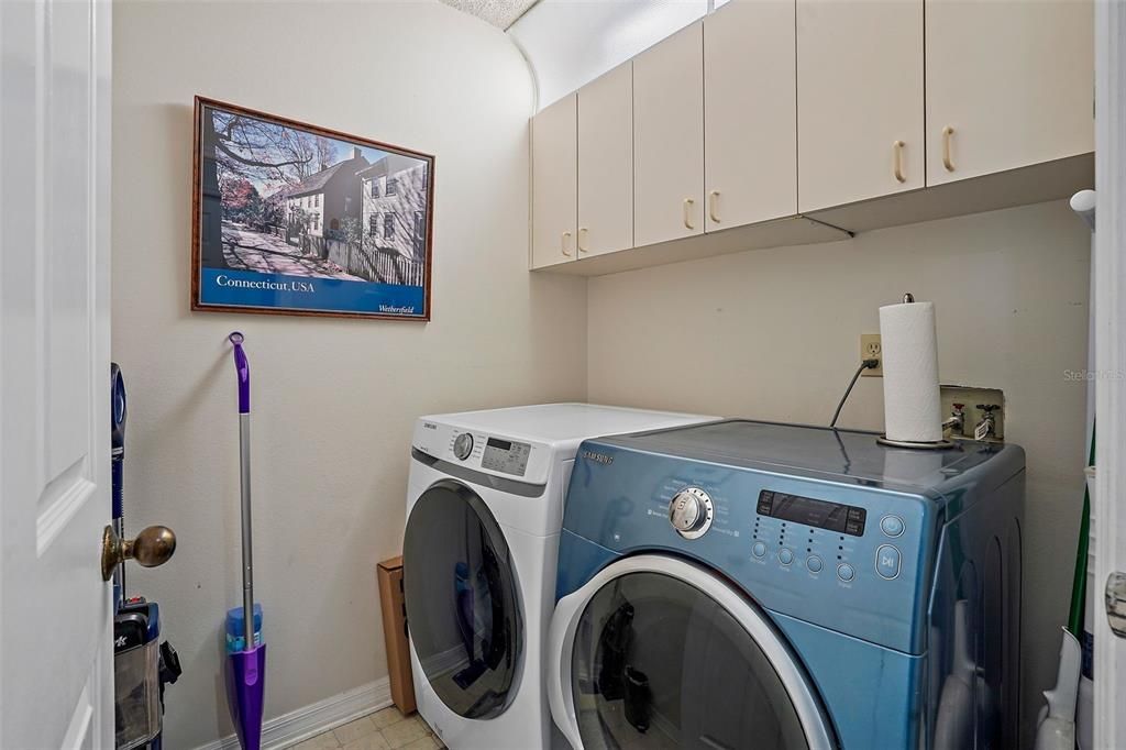 Laundry room located on the 2nd floor level with cabinets for storage