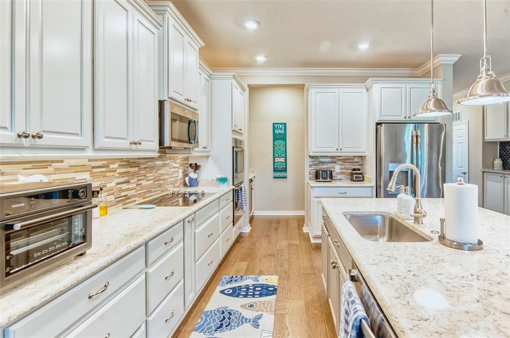 Beyond the kitchen is the butler's pantry with cabinets, counter, and wine fridge!