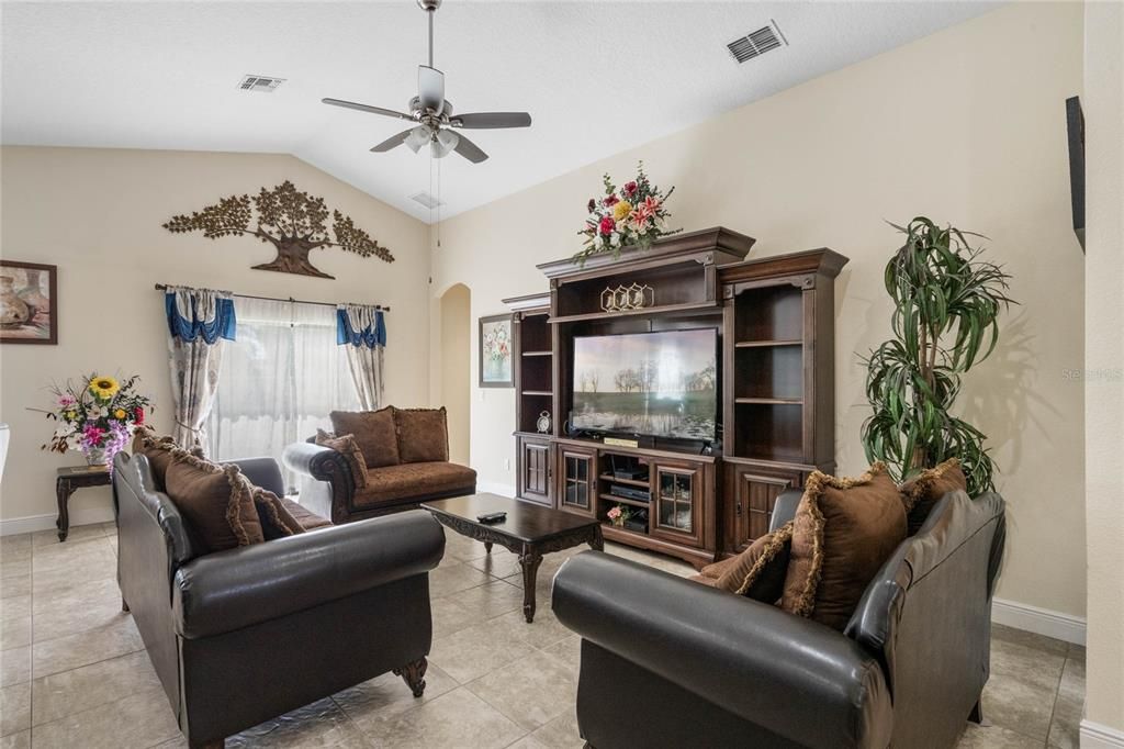 The generous great room gives you living and dining areas open to a modern kitchen, complete with a VAULTED CEILING to add to the light and bright feel and sliding glass door access to the backyard.