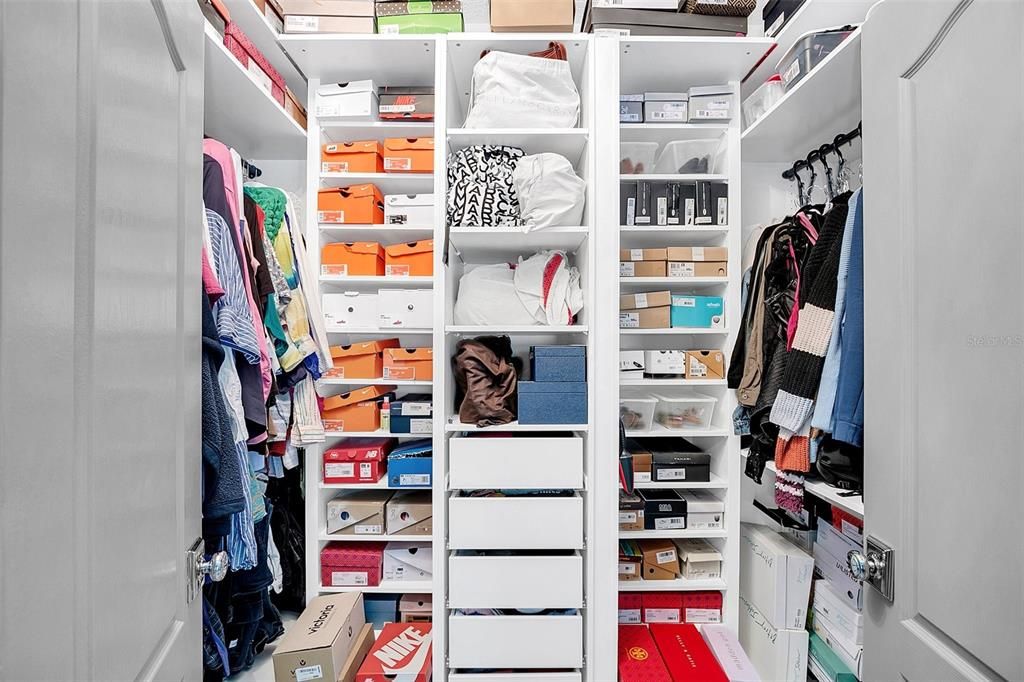 Primary bedroom walk in closet