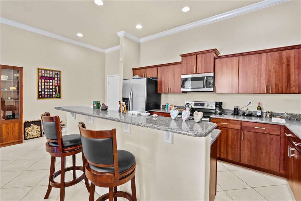 A view of the spacious kitchen countertop and breakfast bar