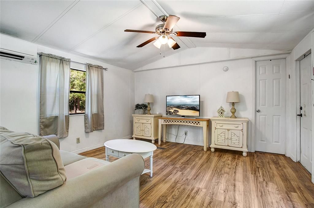 The living area features a ceiling fan and a 3 year old Mitsubishi mini-split unit that is still under warranty.