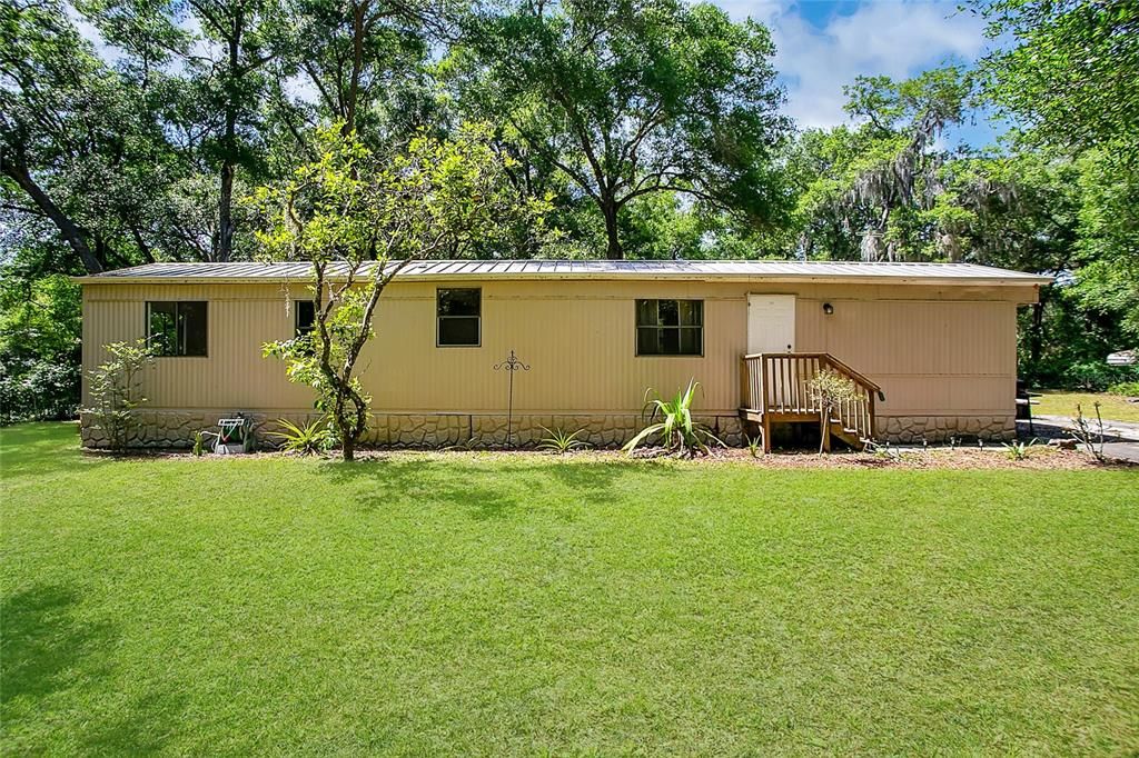 View of 3 bed / 2 bath manufactured home in Ocklawaha, FL! This is the view of the home as it faces the street.