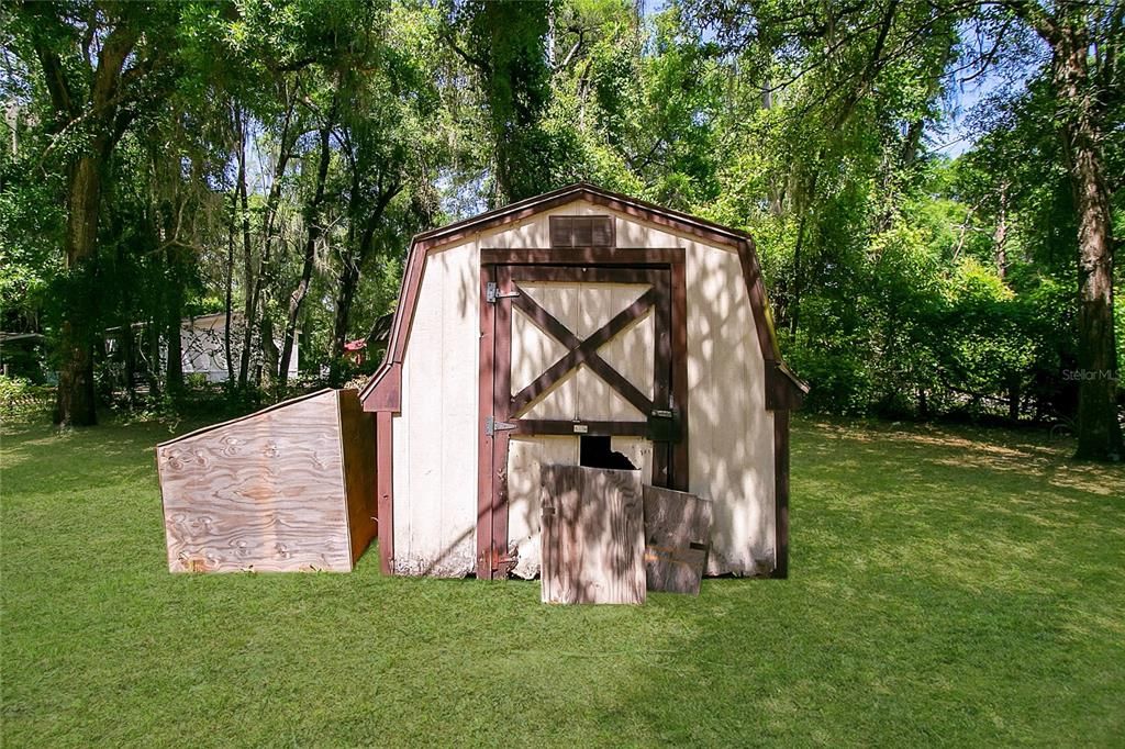 Shed with storage is conveniently situated at the front right corner of the property.
