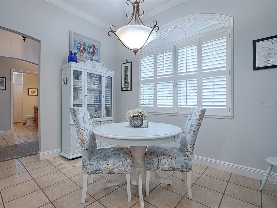 Breakfast nook with bright sunlight and plantation shutters