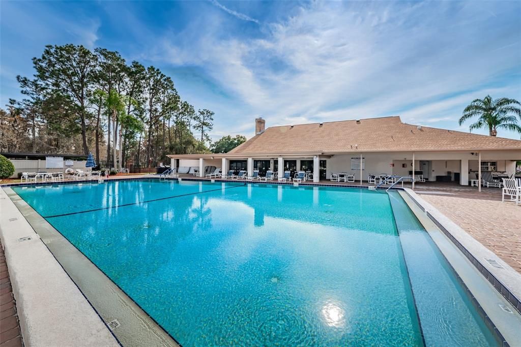 Community pool with a shaded seating area