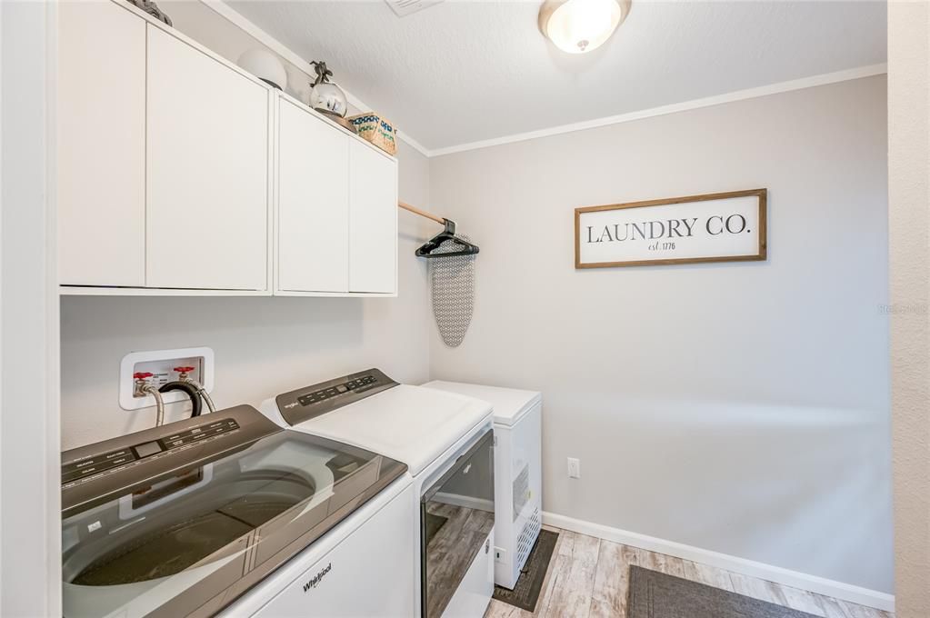 Indoor Laundry Room with washer and dryer included in the sale. This is also a mud room, as it has a backdoor leading to the outdoor oasis.