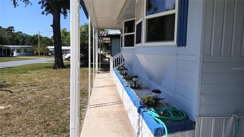 Sidewalk to the front porch and screened in room.