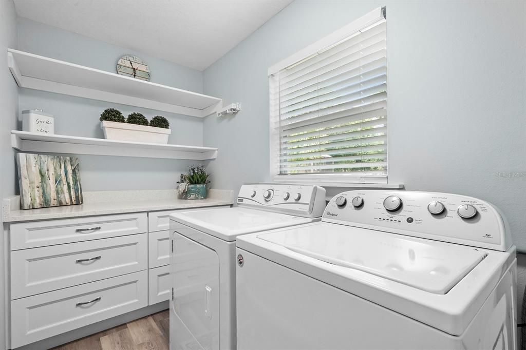 Charming Indoor utility room just off of the kitchen. Plenty of room for folding and storing.