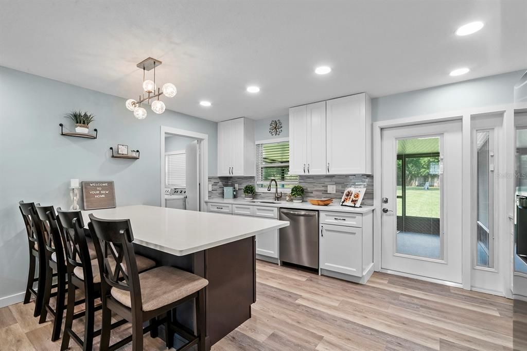 Stainless Steel Appliances in the kitchen are Samsung and Frigidaire. Glass door with matching sidelight to the screened-in back porch have built-in blinds, so no dusting needed!