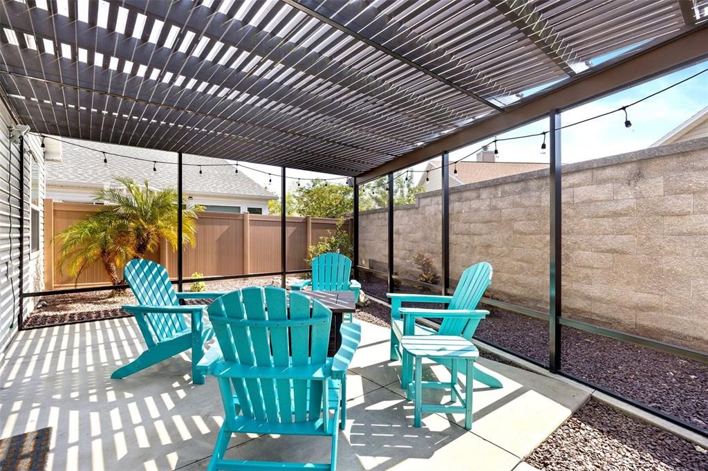 Enlarged, fully SCREENED IN PERGOLA offers a low-maintenance retreat.